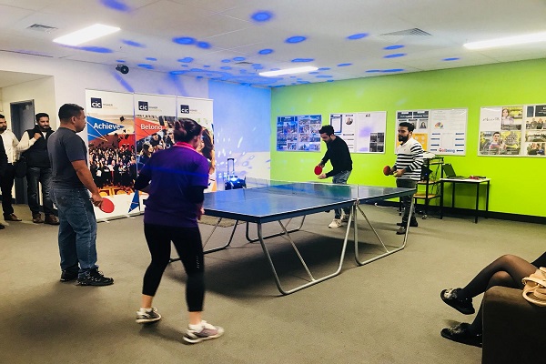 Students play table tennis in a colourful breakout room at BPP Institute